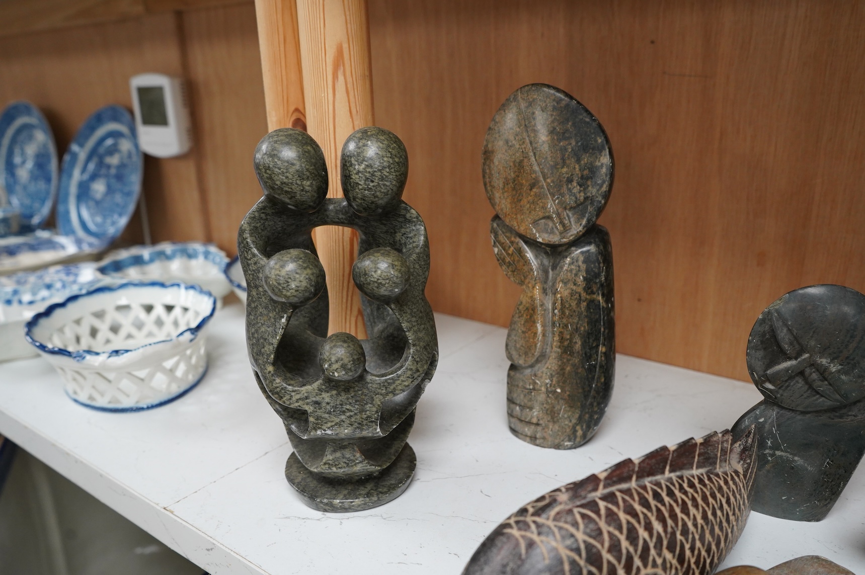 Eleven Inuit related stone carvings, unsigned, to include birds and abstract figures, largest 22cm high